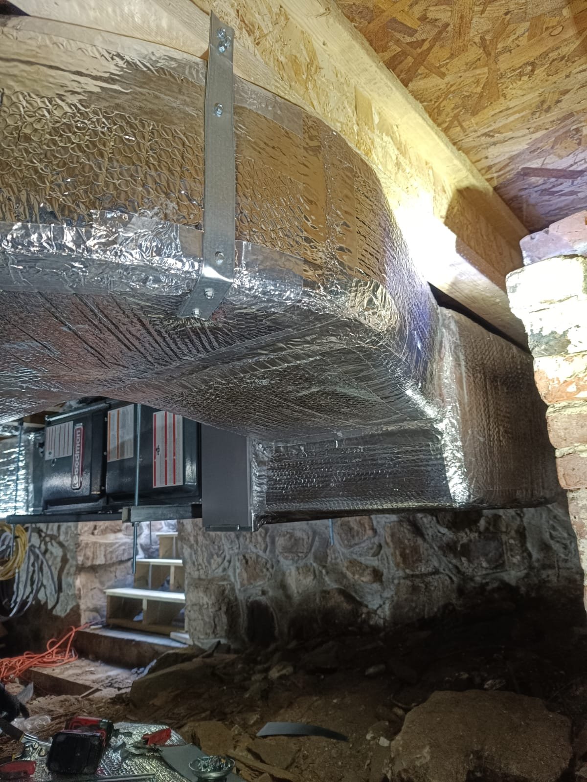 Insulated HVAC ductwork installed in a basement