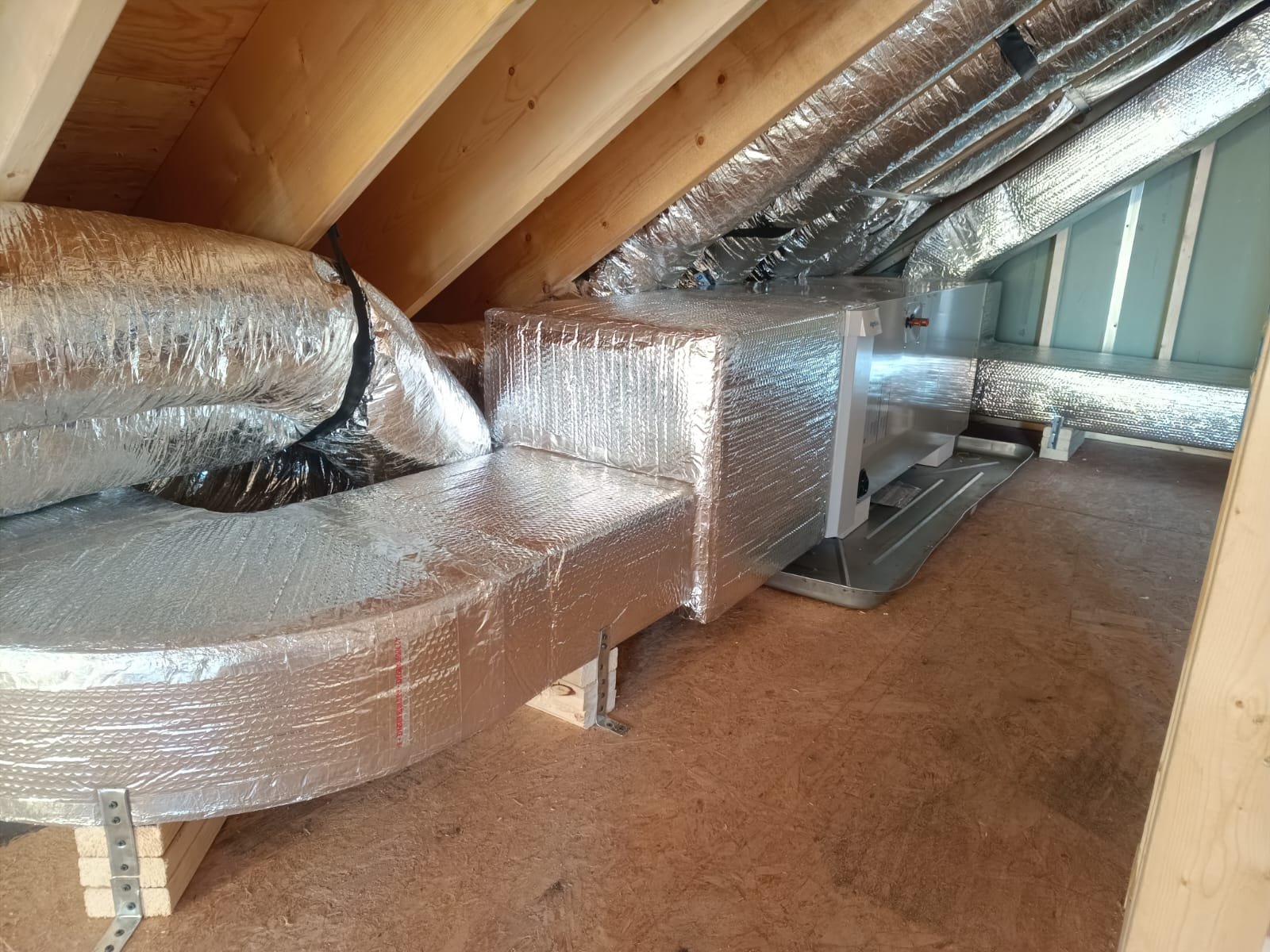 Air handler and insulated ducts in an attic