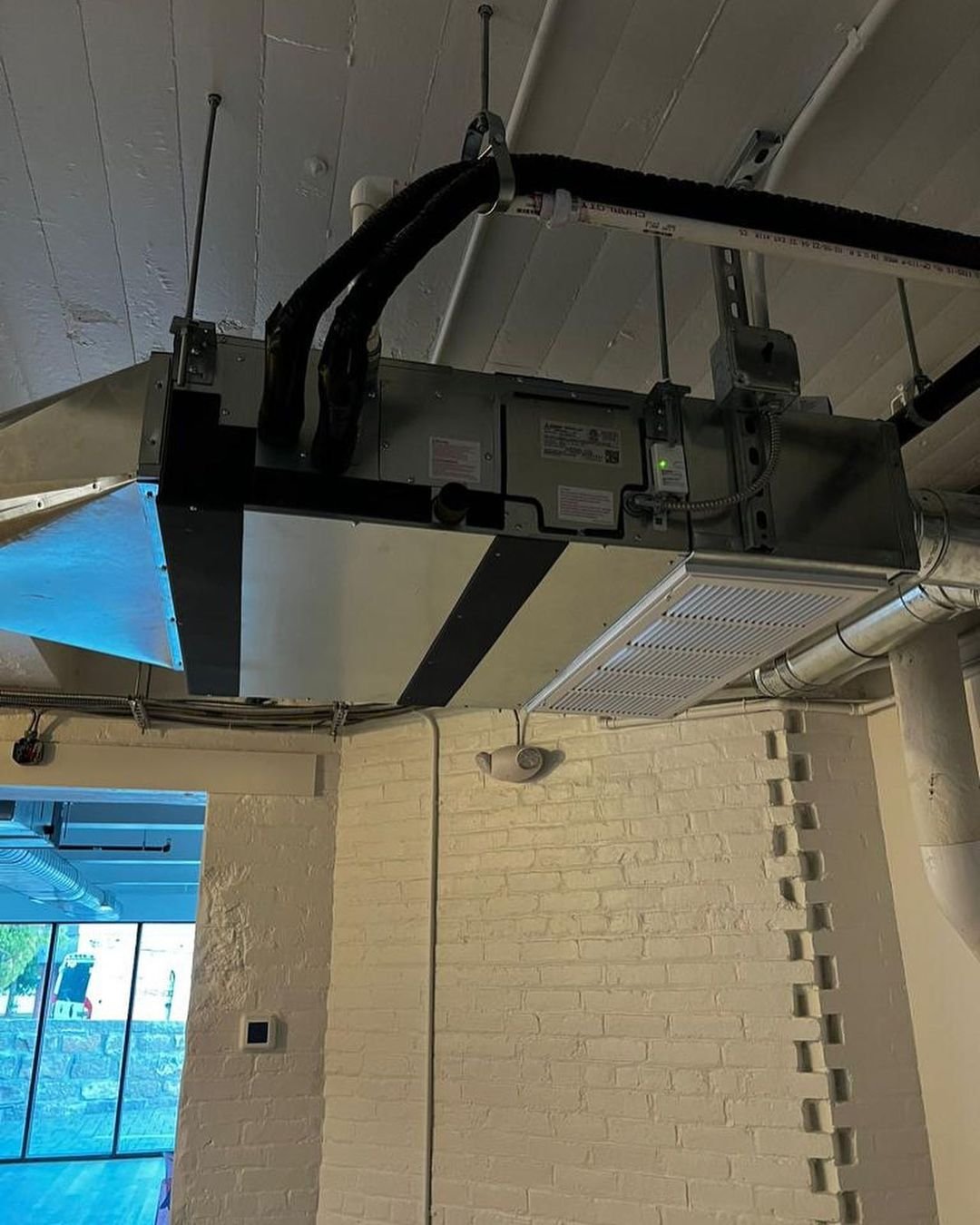 Commercial HVAC unit and ductwork installed in a ceiling