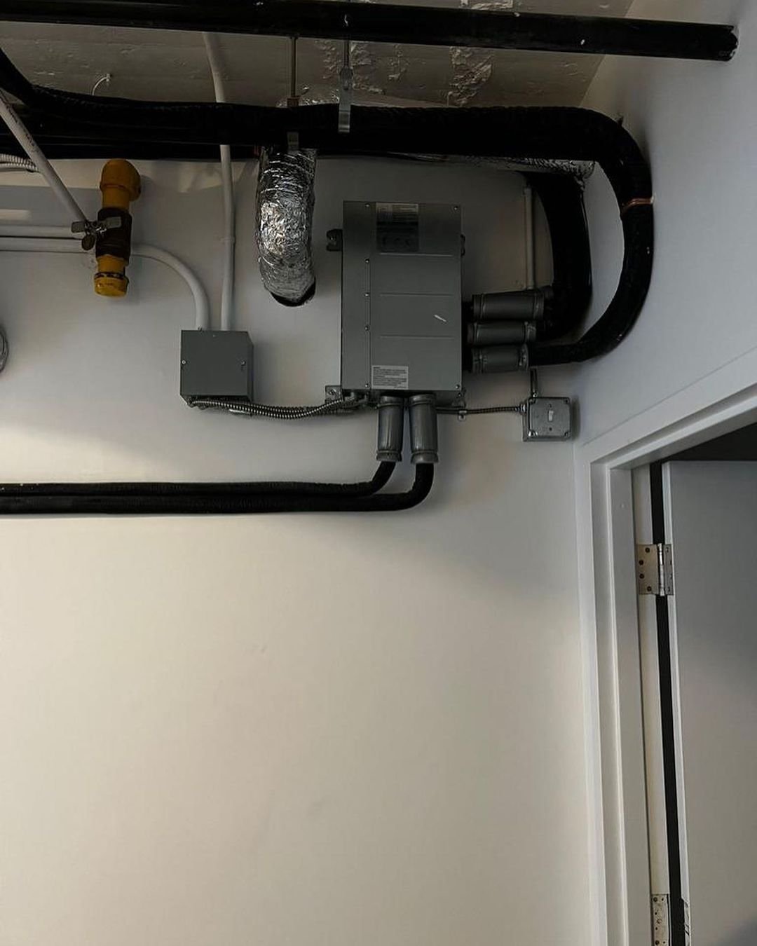 Finished HVAC line sets and equipment on a wall